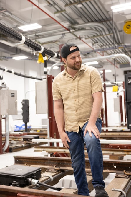 a man in a baseball cap speaks about his experience while inside a job training center