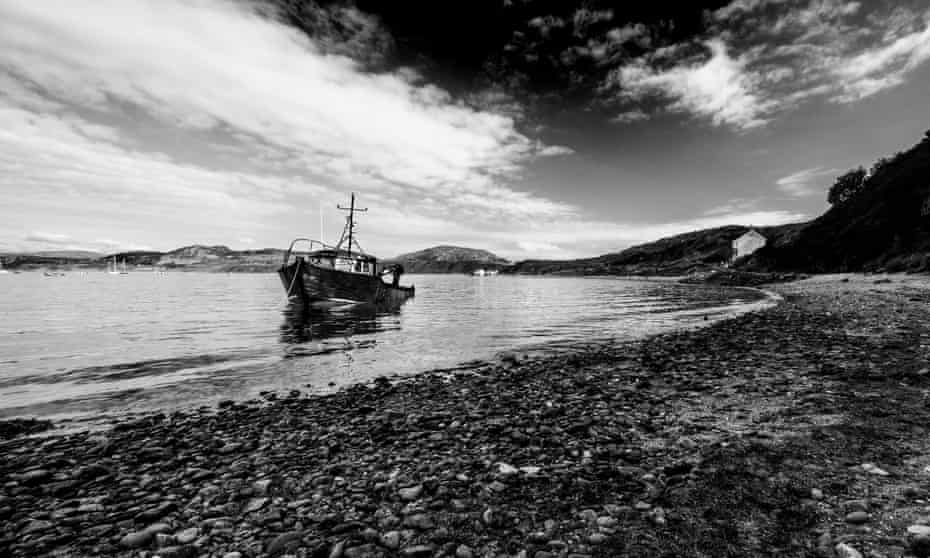 A boat floating in the bay, on the north Wales coast
