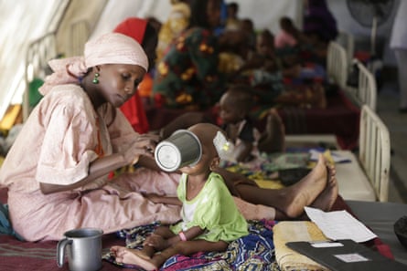 A mother feeds her malnourished child at a nutrition clinic run by Médicins Sans Frontières in Maiduguri