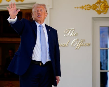 Donald Trump raising his hand outside the Oval Office