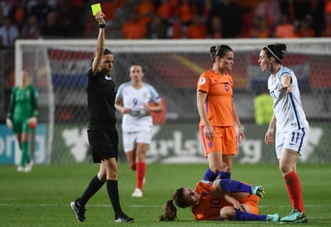 Jade Moore receives the yellow card from French referee Stephanie Frappart.