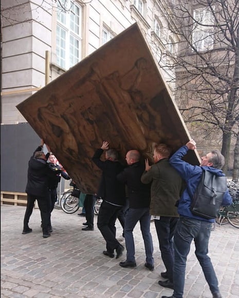 People carrying a painting in Copenhagen