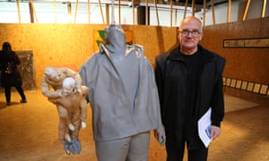 Enver Hadžiomerspahić, a director of Ars Aevi Art Depot, in Sarajevo, poses with exhibits in the museum.