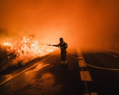 Galician forest firefighting brigades work through the night to control a wildfire in Oia, Pontevedra, Galicia, Spain in August 2025.