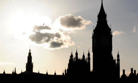 The sun sets behind the House of Commons in Westminster.