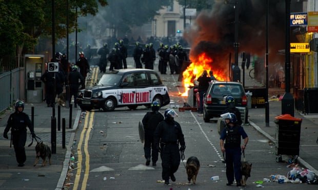 Riot police on the scene after cars were set alight by rioters in Hackney, north London, on 8 August 2011