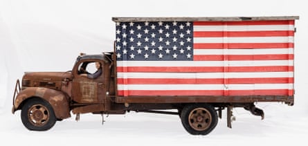 Organic farmer Peter in his Dodge truck, Peconic, New York, US. On the side of his very rusted truck is a huge stars and stripes flag