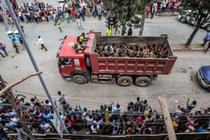 Captured Ethiopian soldiers sit in the bac fo a lorry are paraded through the city, some taken to prison by truck.