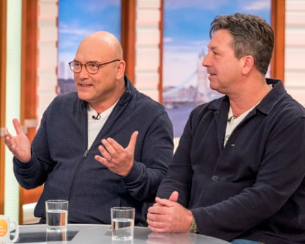 Gregg Wallace gesticulates as he sits next to John Torode on a TV show