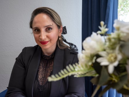 Ketevan Asatiani-Hermann in black jacket next to some flowers