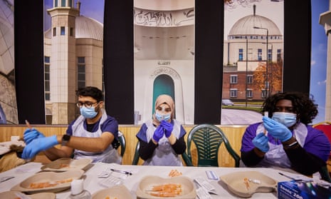 NHS staff prepare vaccinations at a pop-up vaccination centre at the Baitul Futuh Mosque in Morden, London.