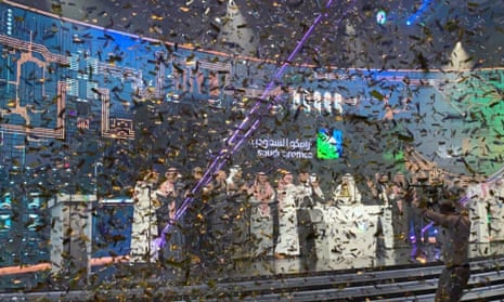 Saudi Aramco executives are showered with ticker tape during a ceremony at the Tadawul stock exchange in Riyadh