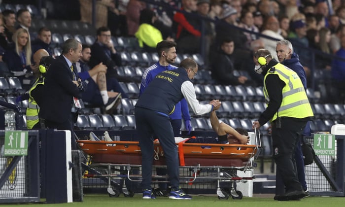 Ukraine coach Oleksandr Petrakov (centre) wishes Scotland's Nathan Patterson a speedy recovery as he is carried off the pavement.