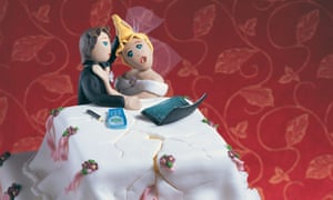 Wedding cake with bride and groom figure sitting at a desk arguing