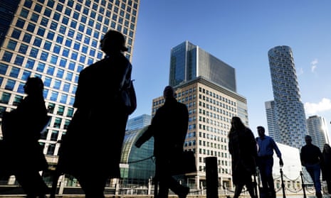 Office workers and commuters walking through Canary Wharf in London. 