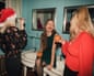 Young women are drinking and applying makeup in the bathroom at a house party.