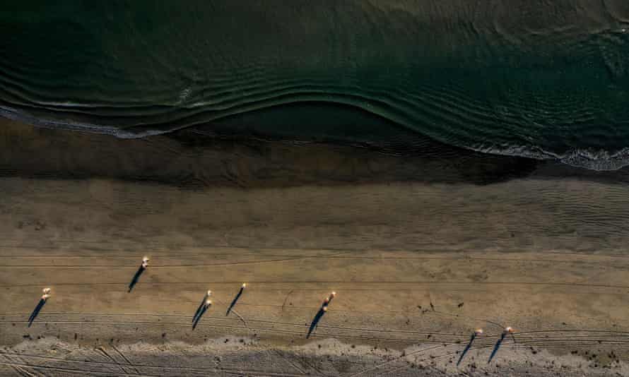 An aerial view of environmental oil spill cleanup crews after a major oil spill at Huntington Beach.