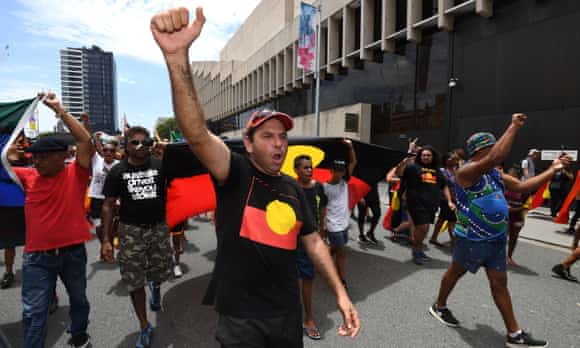 Indigenous protesters march through central Brisbane to protest what the call 