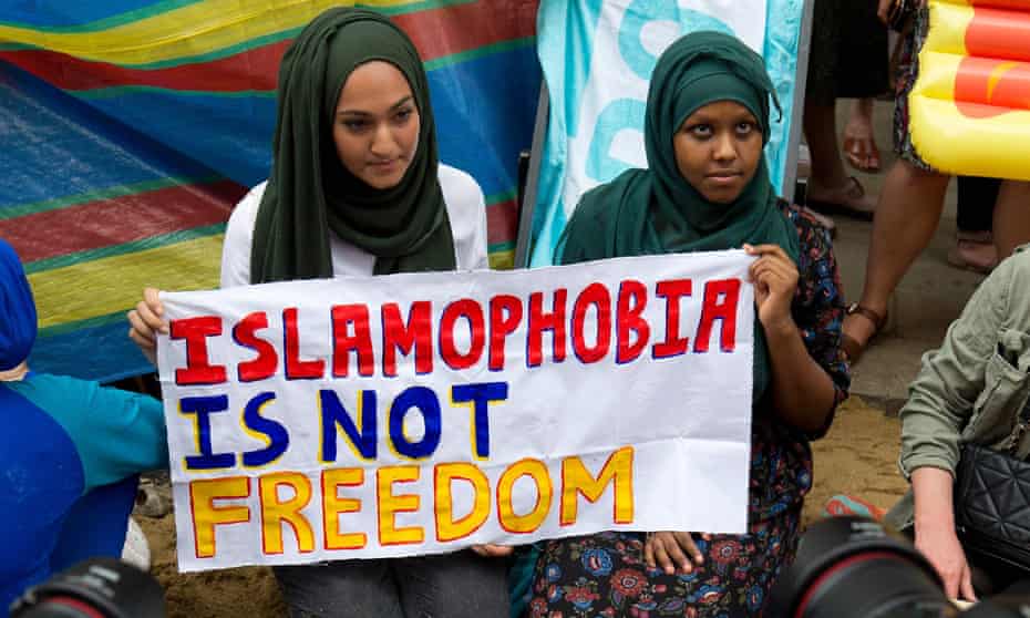 Protesters hold a sign outside the French Embassy during a “Wear what you want beach party” to demonstrate against the ban on burkinis on French beaches and to show solidarity with Muslim women.
