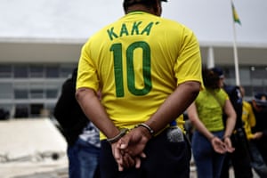 Handcuffed protester wearing footballer Kaka's Brazil shirt