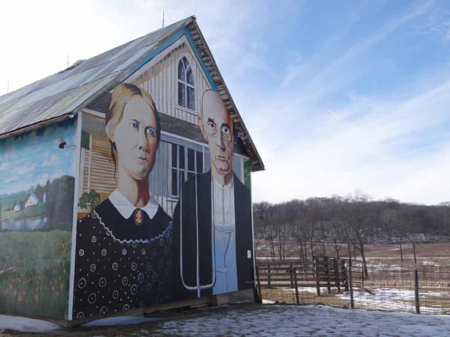 A barn on the road to Clinton, Iowa, decorated with American Gothic by Grant Wood.