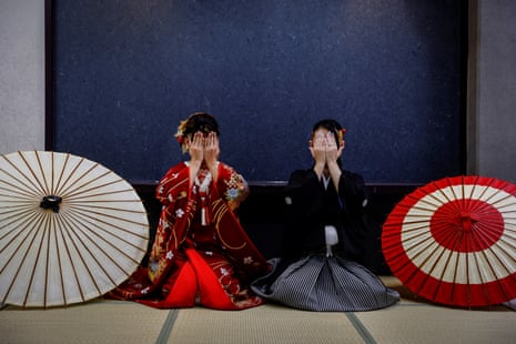 A transgender couple in kimonos pose for wedding photos