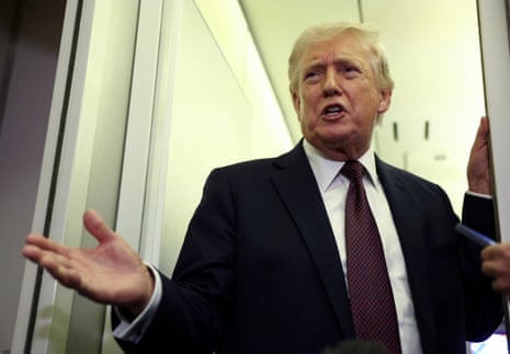 US President Donald Trump speaks to reporters aboard Air Force One on a flight back to Washington 15 March 2026.