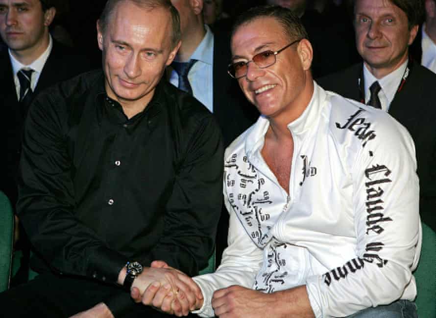 Putin shakes hands with martial arts movie star Jean-Claude Van Damme as they watch a mixed fight event in St Petersburg in 2007.