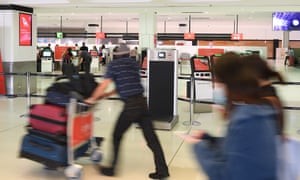 A Qantas check-in area at Sydney international airport this week. Restrictions on foreign travel have been implemented in Australia as the coronavirus outbreak worsens. 