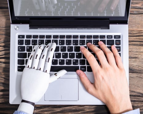 Man with a prosthetic hand working on a laptop