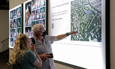 People look at plans on a wall