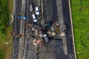 An aerial view of burnt cars and debris blocking a road in the neighbourhood of Lamentin after unrest triggered by Covid-19 curbs, which have have already rocked the nearby island of Guadeloupe, in Fort-De-France.