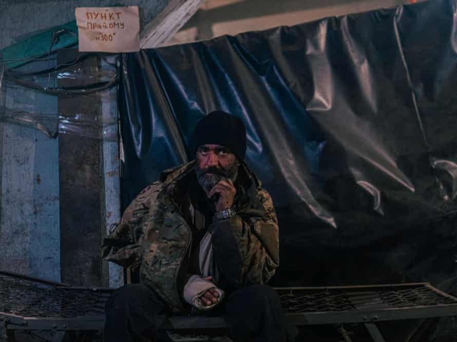 A man in a sling stares at the camera as Russian troops continue their assault of the Azovstal steel works in Mariupol.