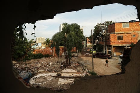 A woman walks in the mostly demolished Vila Autodromo favela community