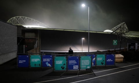 A fan walks past information signs before the Brighton & Hove Albion v Southampton Premier League match on 7 December.