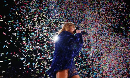 Taylor Swift performs on stage amid a sea of confetti