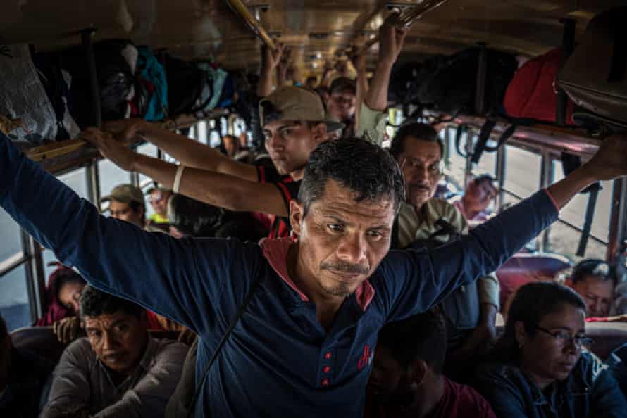 José Basilio standing in a crowded bus.