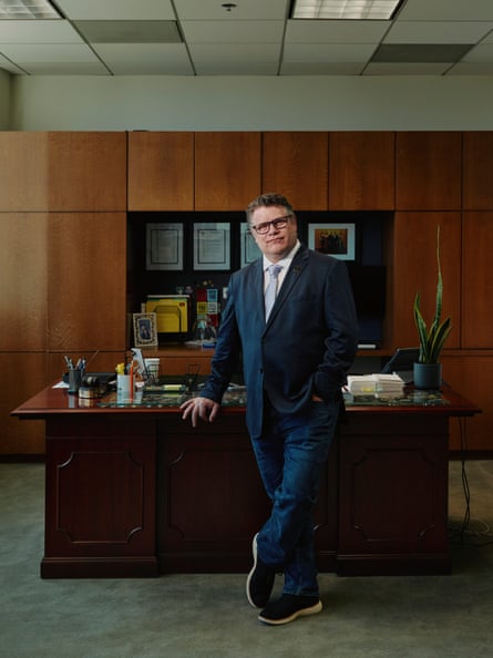 Astin poses for a portrait at his desk, at the SAG-AFTRA office