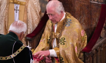 King Charles III holds the coronation ring during the ceremony 