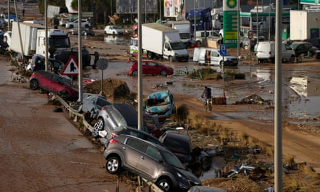Vehicles are seen piled up after being swept away by floods on a motorway in Valencia, Spain