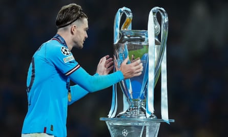 Jack Grealish touches the Champions League trophy after beating Internazionale