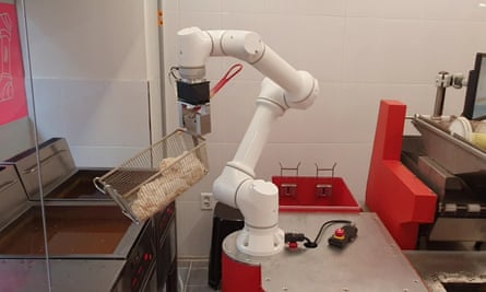 A robotic arm fries chicken at a fast-food restaurant in South Korea