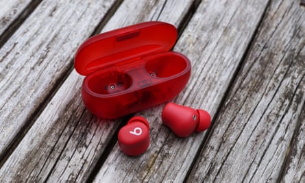 The Beats Solo Buds and case sitting on a table.