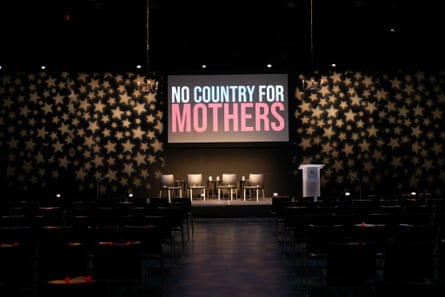 Chairs in front of a screen showing “No Country for Mothers” a the premiere in Minneapolis.