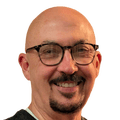 Smiling bald man with glasses and goatee