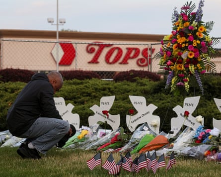 A man prays at a memorial at the scene of a weekend shooting at a Tops supermarket in Buffalo, New York.