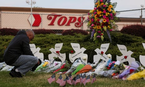 A man prays at a memorial at the scene of the shooting at Tops supermarket in Buffalo, New York.