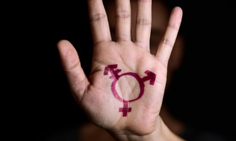 A transgender symbol painted in the palm of a person's hand