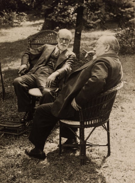 Freud and his brother Alexander in 1936, sitting in wicker chairs in a garden