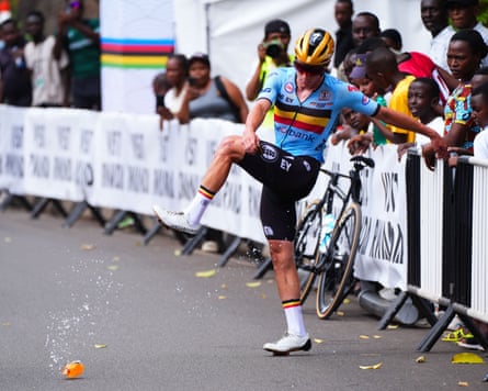 Remco Evenepoel kicks a water bottle in frustration as he waits for a replacement bike.